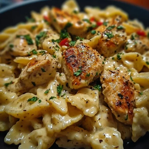 A delicious serving of Cajun Chicken Pasta with colorful vegetables and creamy sauce.