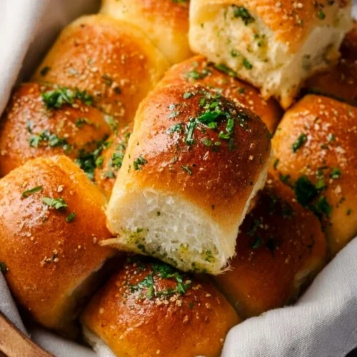 Homemade garlic bread rolls fresh out of the oven, golden and fluffy
