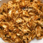 A close-up of savory shredded chicken appetizers arranged on a platter.