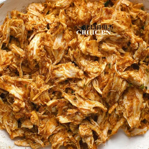A close-up of savory shredded chicken appetizers arranged on a platter.